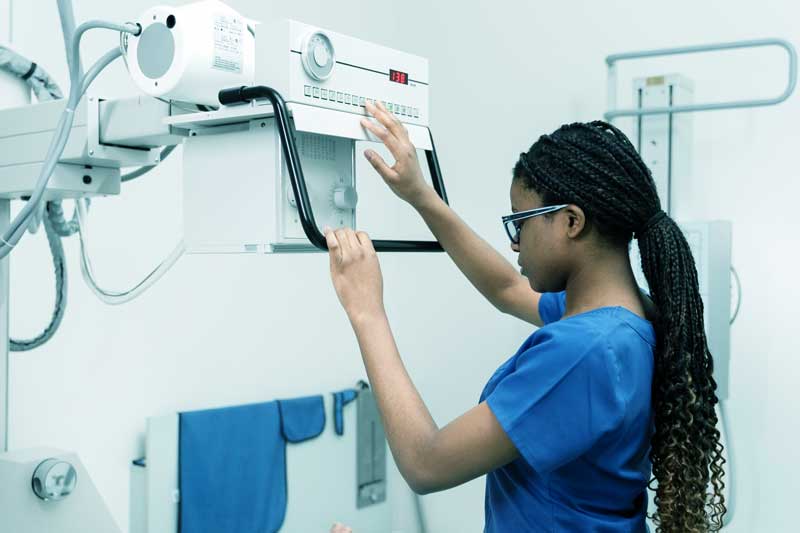 Medium shot nurse preparing x-ray machine of umy medical