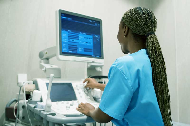 Nurse controls ultrasound machine of umy medical while working at the clinic